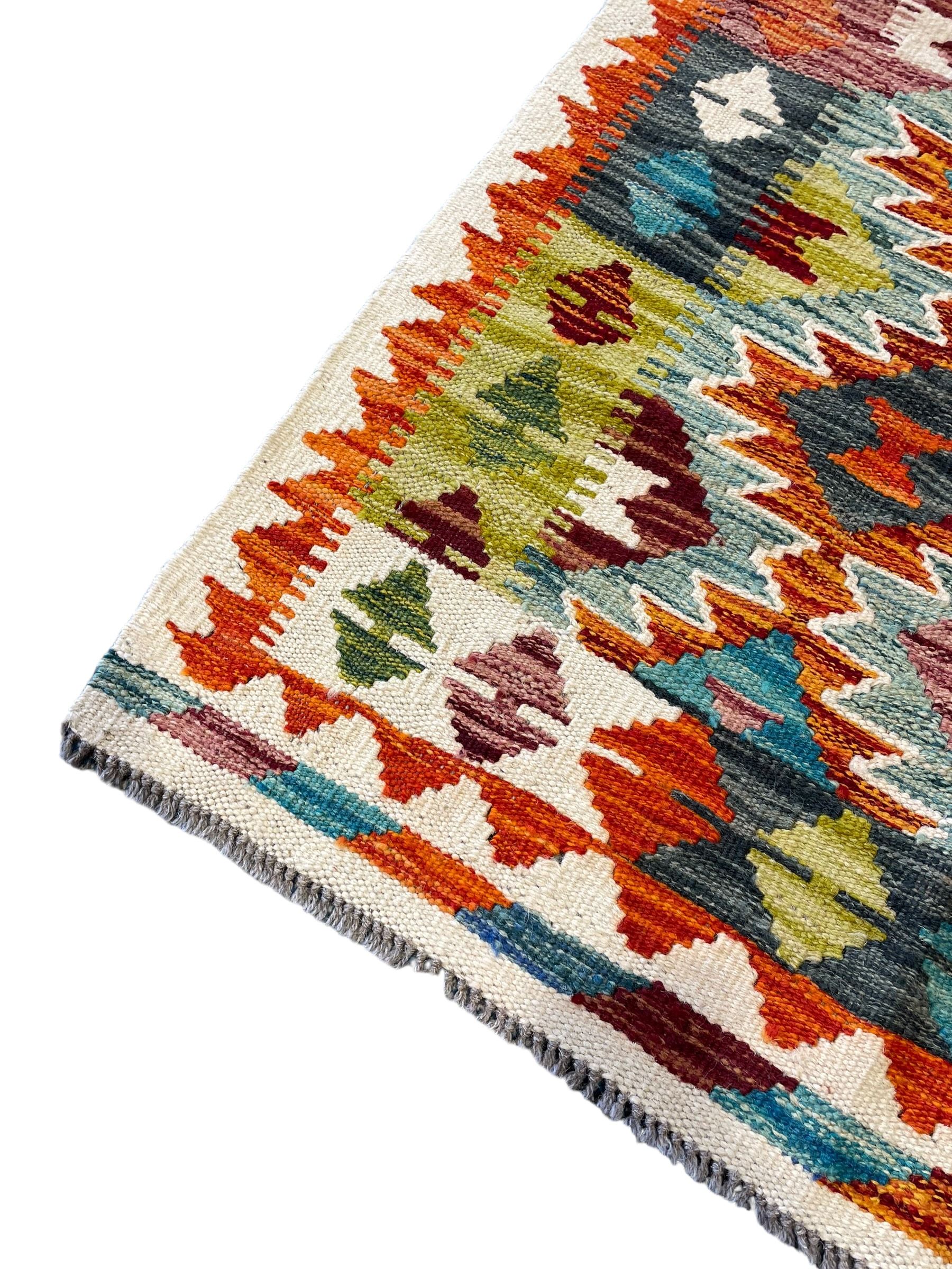 Chobi Kilim ivory ground rug, the busy multi-coloured field decorated with two concentric lozenges, the guard lines decorated with broken-lozenge motifs and geometric designs