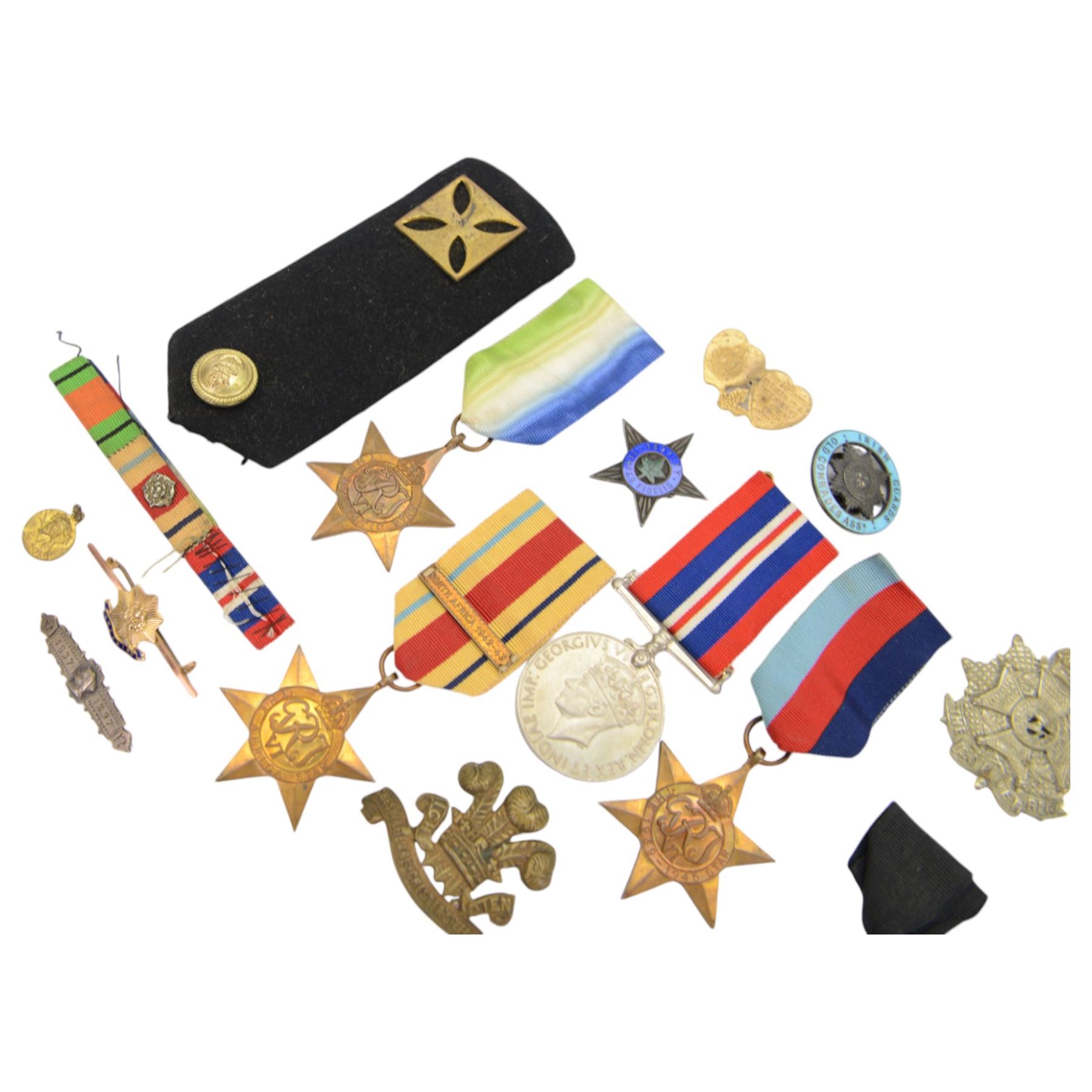 WWII group of four medals comprising 1939-45 star, Atlantic Star, African Star and War medal, together with various cap badges etc  