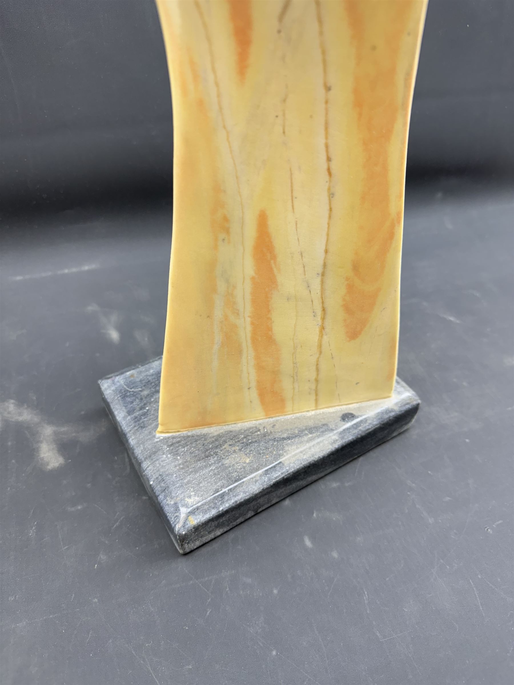 Abstract marble sculpture modelled as a dancer, upon a rectangular base, H58cm