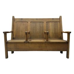 Early 20th century oak settle, featuring a high back with three panel sections and hinged lids, the bench seat divided into three sections, each with its own armrests, supported by square legs