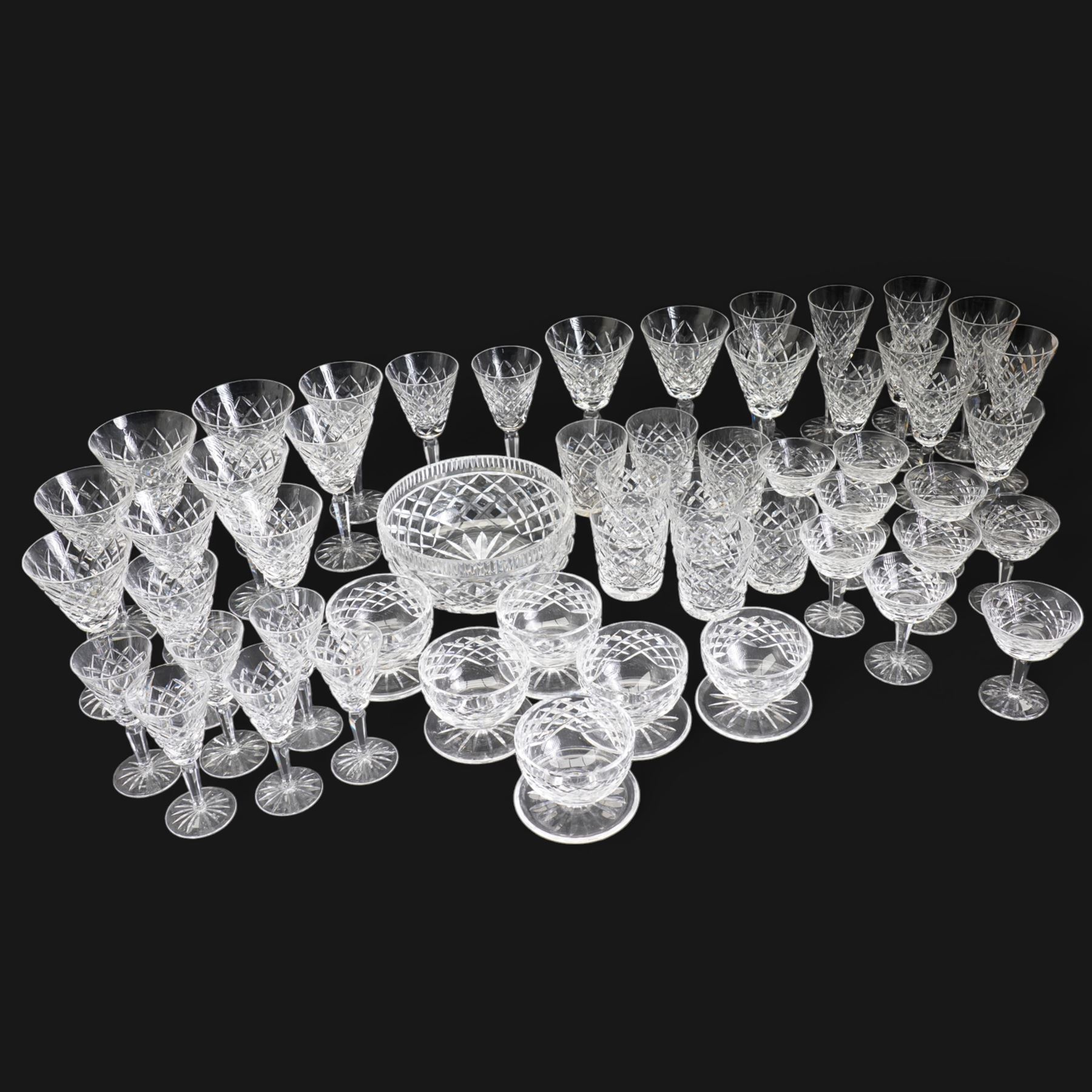 Suite of Waterford Tyrone pattern crystal to include six water goblets, H18cm, six red wine glasses, H17cm, seven white wine glasses, H16cm, six champagne flutes H18cm, six port glasses H14cm, nine champagne coupes, eight tumblers, six dessert bowls and serving/ fruit bowl