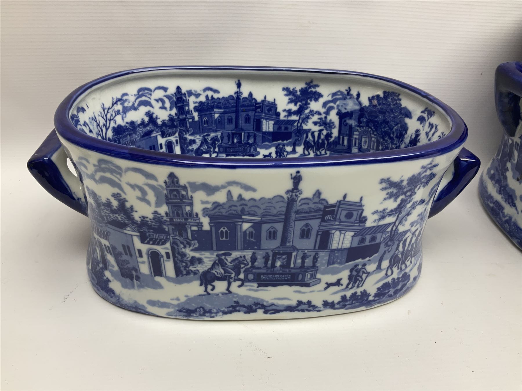 Three Victoria Ware blue and white footbaths, each with twin lug handles and transfer print decorated with city scape, largest H21cm