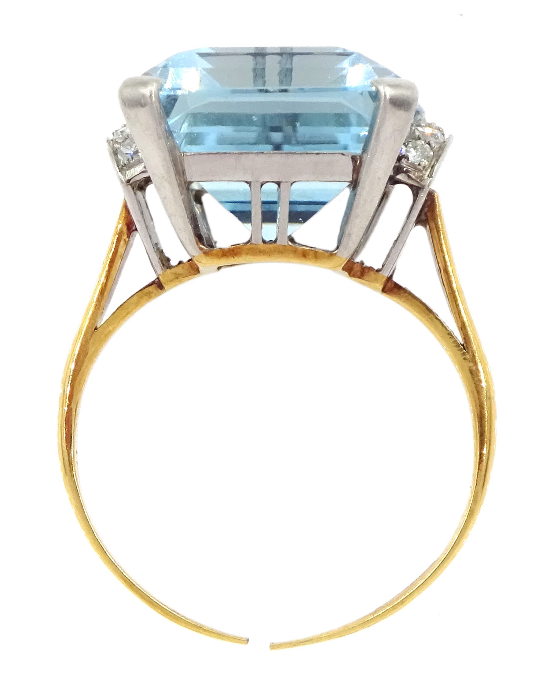 18ct gold single stone emerald cut aquamarine ring, with four channel set diamonds set either side, aquamarine approx 11.15 carat