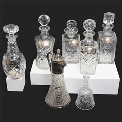 Six crystal decanters, four with silver labels and one with silver plated mount, and one e...