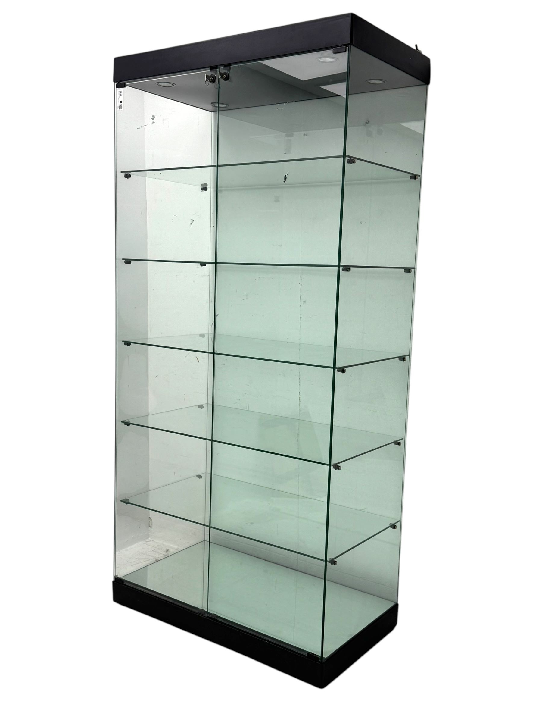 Glazed shop display cabinet fitted with two doors, six shelves with illuminated interior