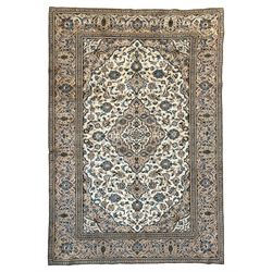 Persian Kashan ivory ground rug, the field decorated with interlacing branches and palmett...