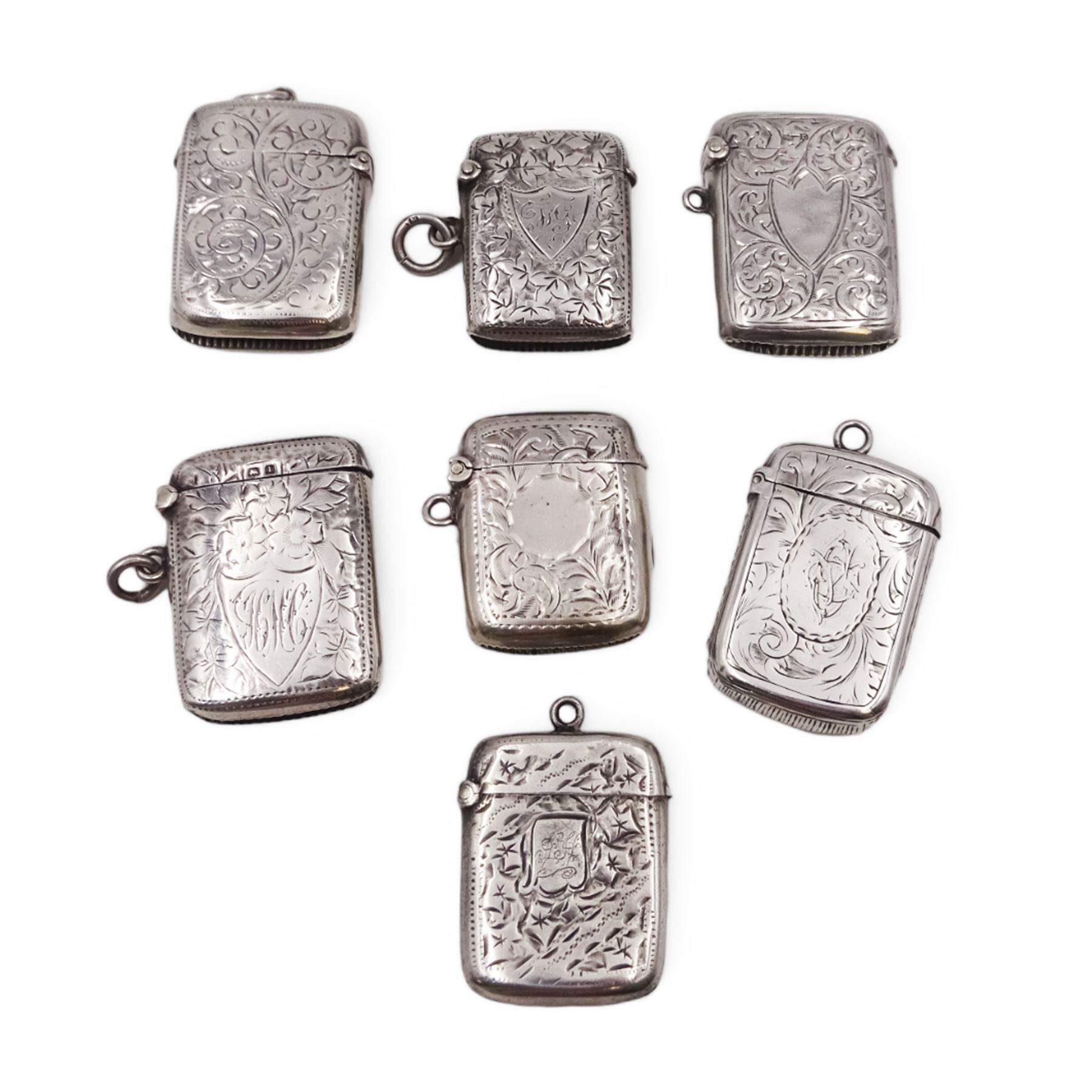 Seven early 20th century silver vesta cases, all of typical form, engraved with foliate and scrolling details, all hallmarked