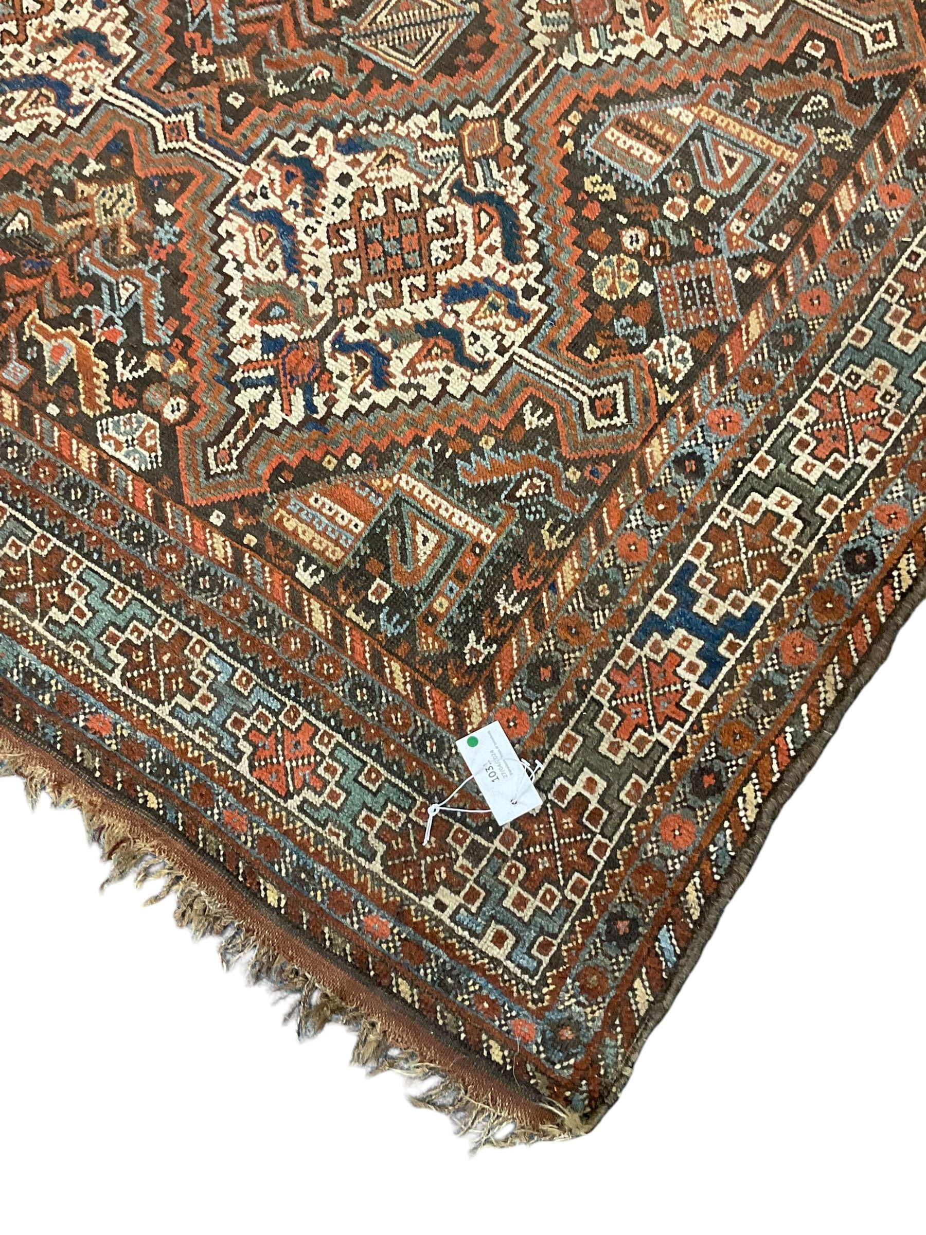 Persian rug, overall geometric design, the field with six interlinked lozenge medallions surrounded by stylised animal and geometric motifs, multiple band border with geometric patterns 