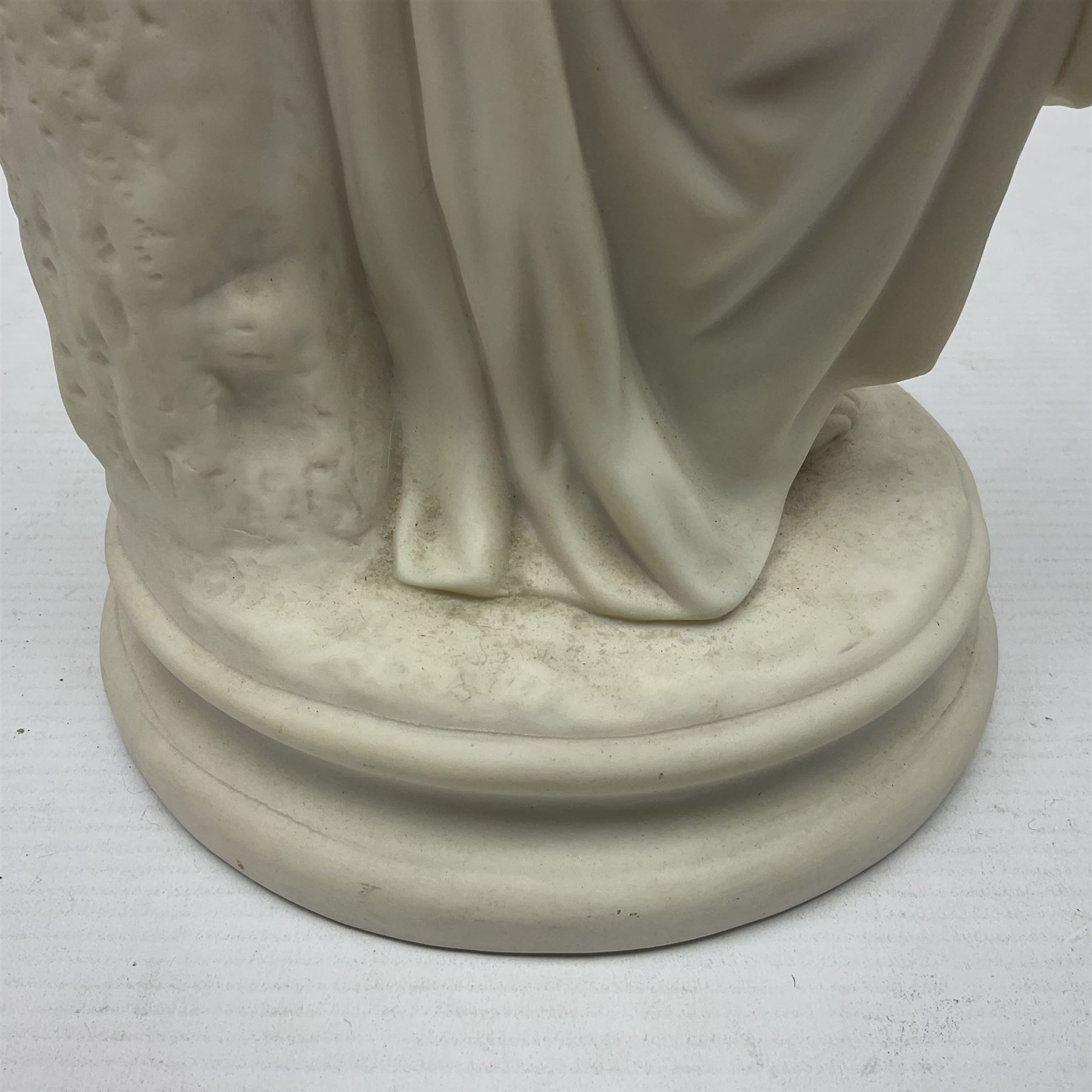 Parian figure modelled as a female in classical dress leaning upon a tree stump, H36cm