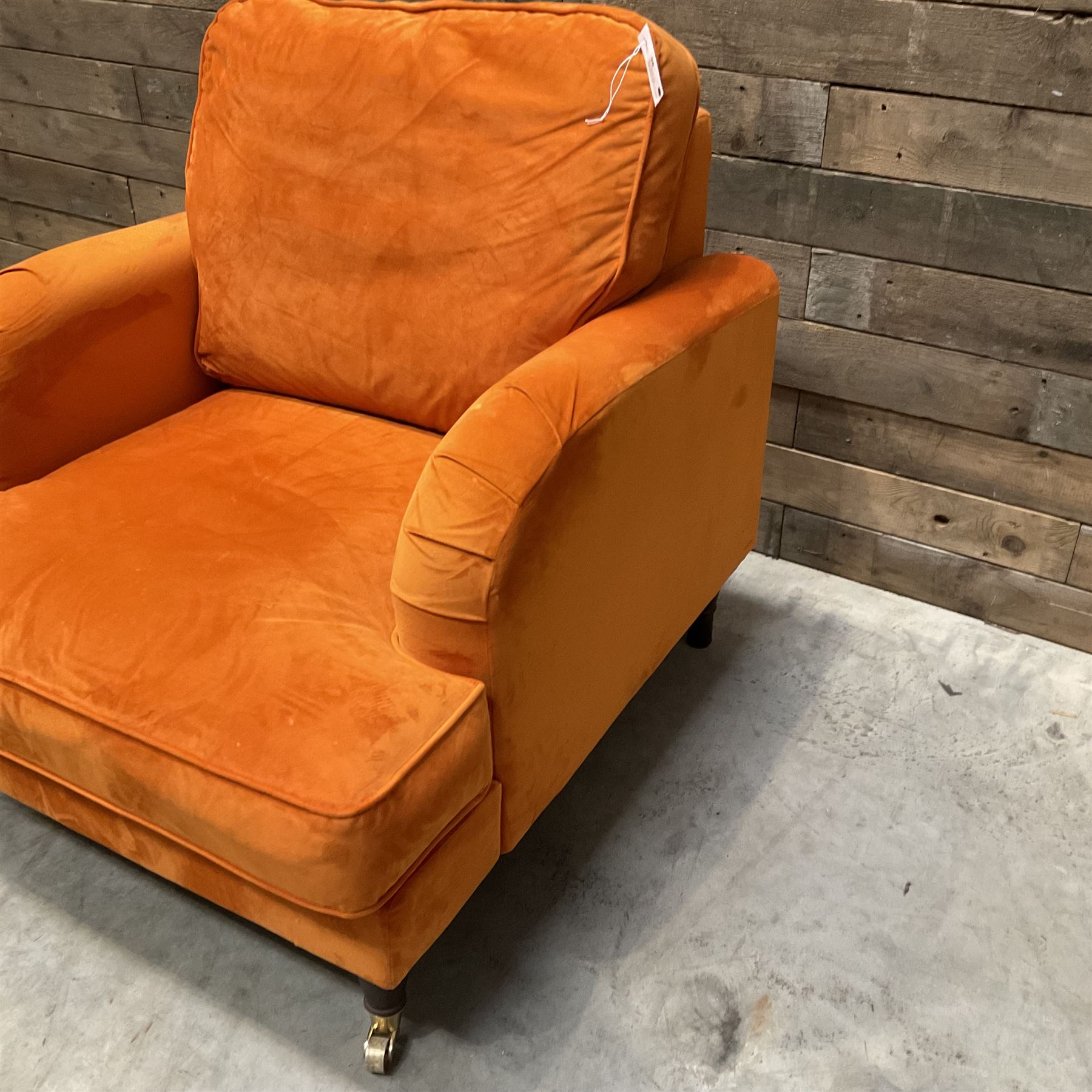 Armchair upholstered in orange velvet fabric