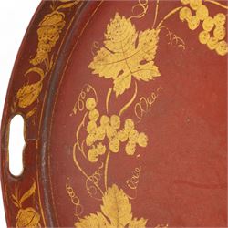 19th century red and parcel gilt toleware tray, of oval form with pierced handles, decorated with bands of fruiting vines and shells, L72cm x W55.5cm