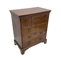 18th century oak and walnut chest, fitted with four small over three long drawers with figured walnut facias, brass handles and plates with engraved decoration, on bracket feet