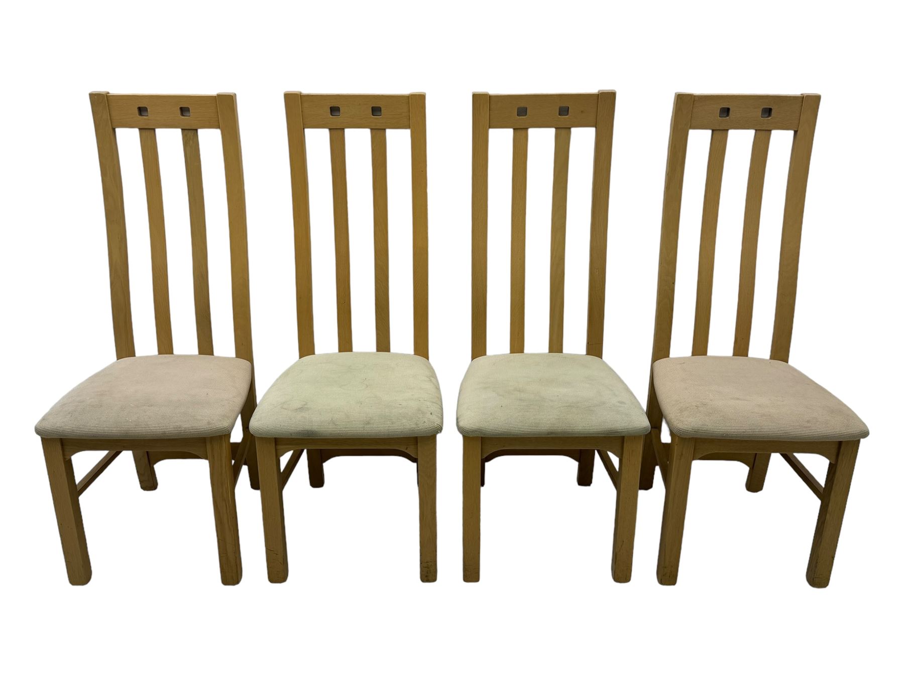 Contemporary set of four oak dining chairs, tall slatted curved backs with square cutouts to the top, upholstered seats in light fabric, on square front supports