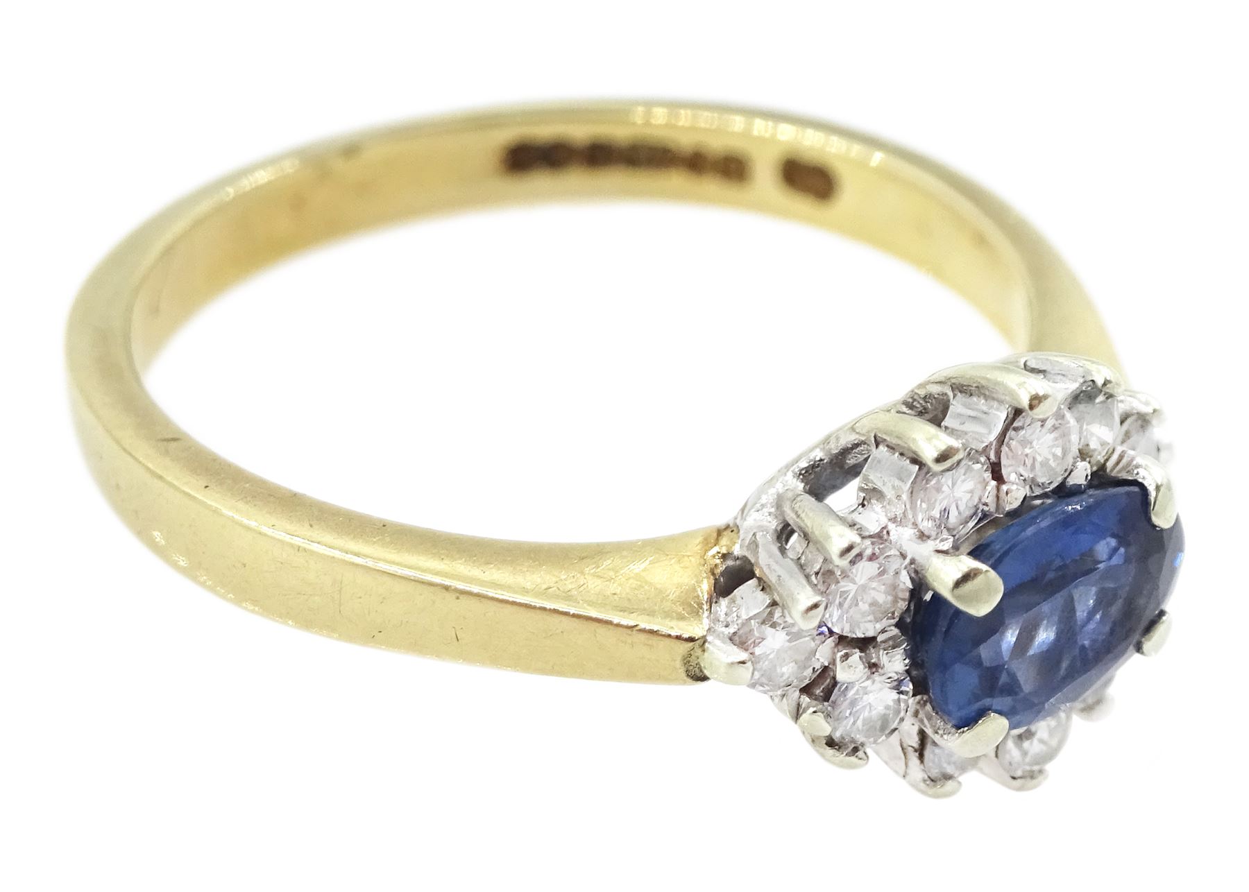 9ct gold oval sapphire and round brilliant cut diamond cluster ring, hallmarked London 1994, sapphire approx 0.55 carat, total diamond weight approx 0.25 carat