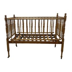 Victorian beech and pitch pine crib, turned spindle gallery supports, raised on square tapering supports with castors