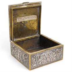 Pair of silver cylindrical dressing table boxes and covers embossed with trailing foliage H7cm, silver upright table photograph frame Birmingham 1909, Indian white metal and glass paperweight and a silver on copper trinket box