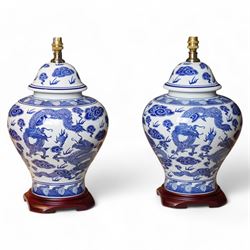 Pair of table lamps of lidded baluster form, decorated with dragons chasing flaming pearls...