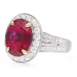 18ct white gold oval cut rubellite tourmaline and round brilliant cut diamond cluster ring, with diamond set shoulders, hallmarked, rubellite 3.93 carat, total diamond weight 0.86 carat 