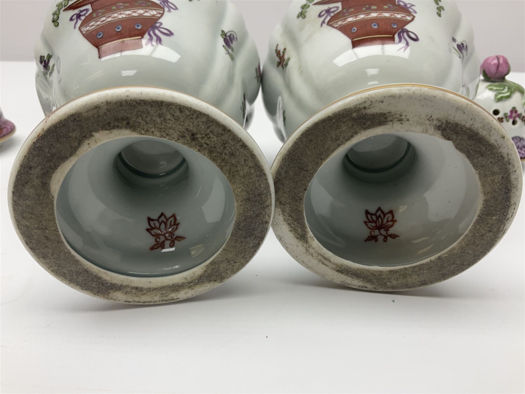 Pair of pot pourri vases and covers, decorated with floral sprigs and with rose finials to the covers, H24cm