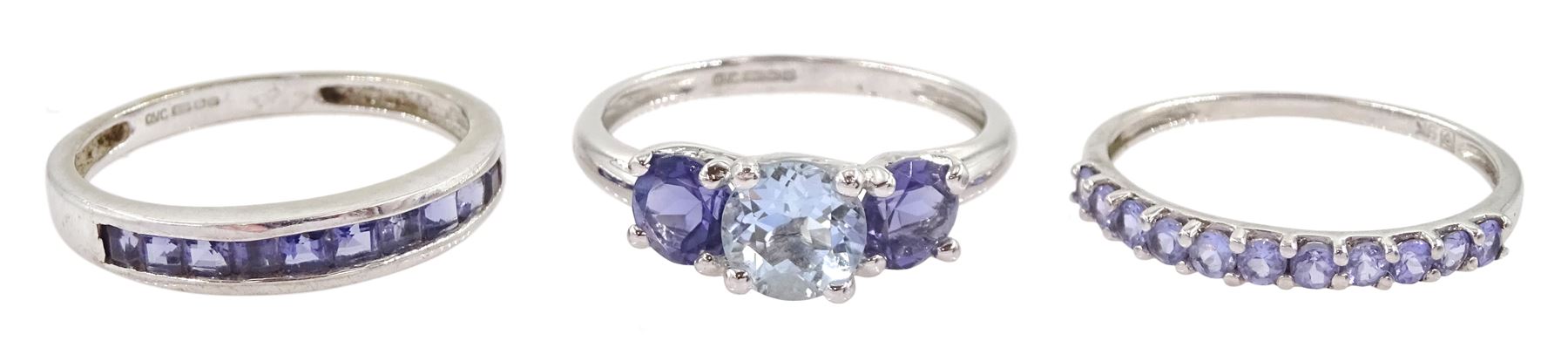 White gold three stone aquamarine and tanzanite ring and two white gold tanzanite half eternity rings, all 9ct