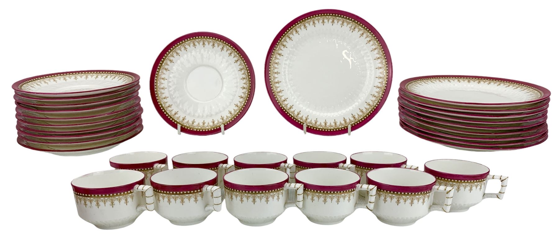 Victorian Aesthetic Movement porcelain tea set by Edwin J. Bodley, circa 1876, decorated with gilt and pink borders on a low relief leaf pattern plain ground, the teacups with bamboo moulded and gilt handles, comprising eleven cups, eleven saucers and ten tea plates, pattern no. 3257 