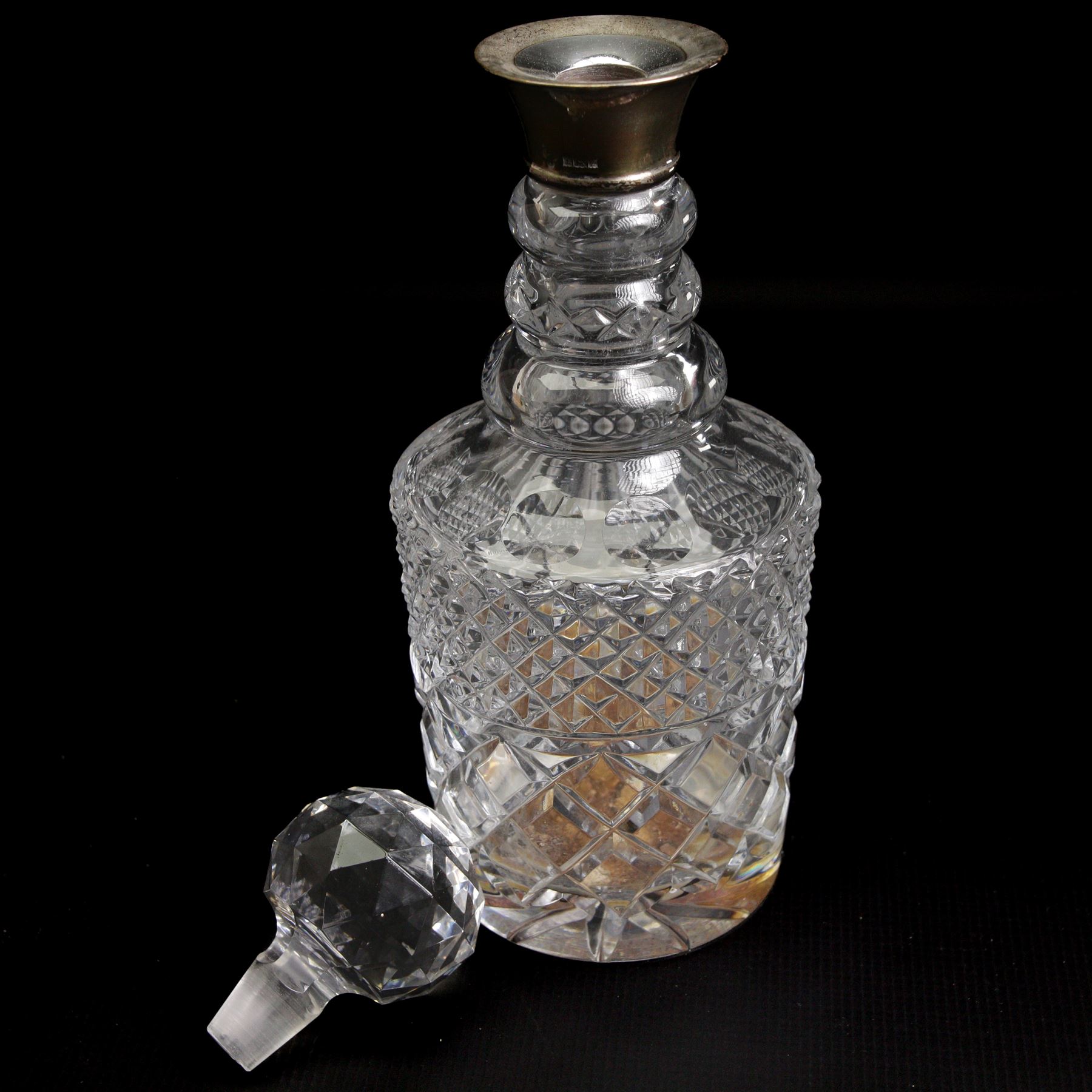 Square glass spirit decanter with silver collar and square stopper and two other decanters with silver collars (3)