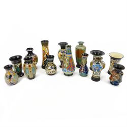 Fourteen Dutch Gouda earthenware vases and similar, all with colourful floral designs upon...