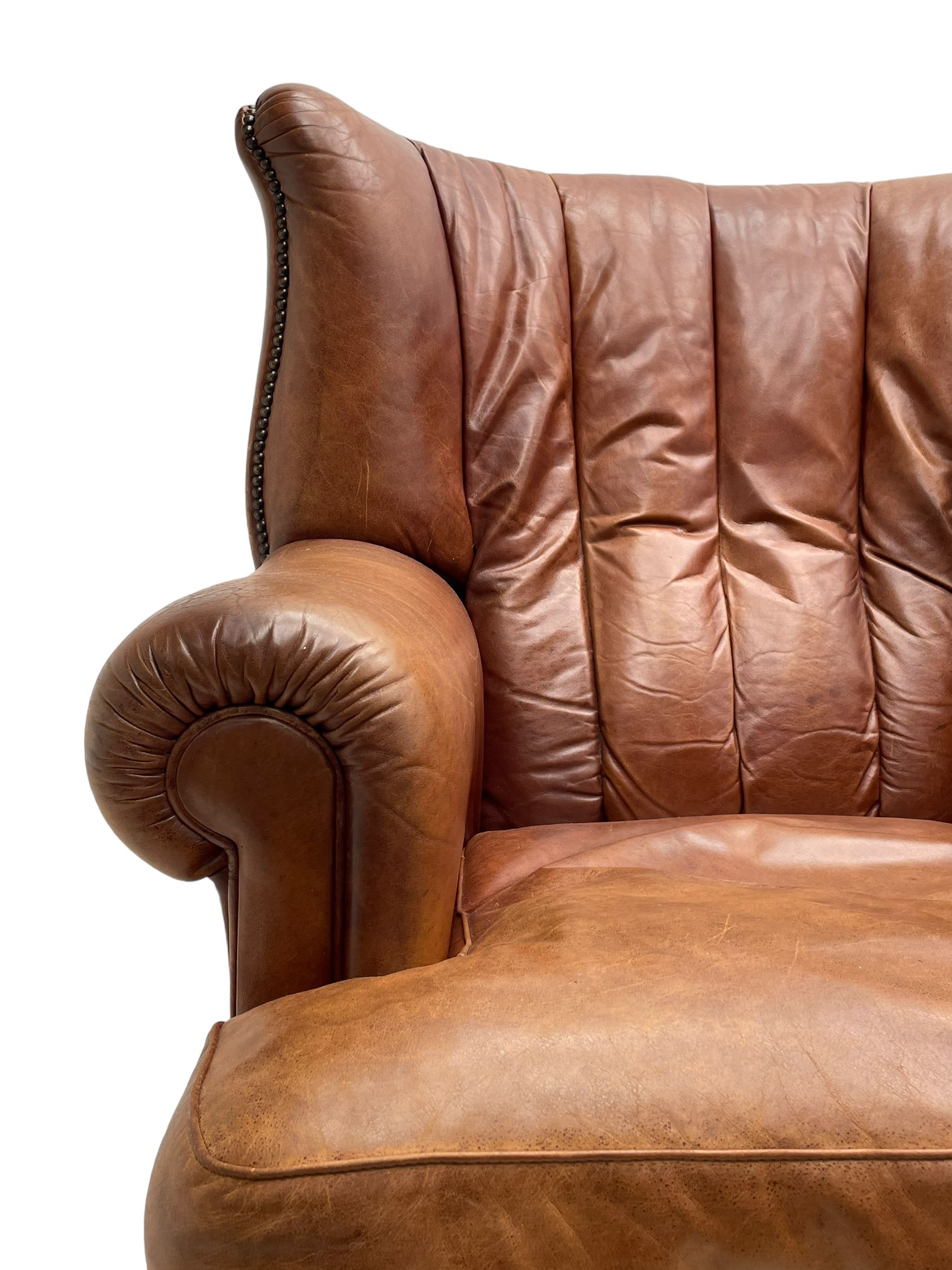 Tetrad - 'Blake' club armchair, fanned wingback and rolled arms upholstered in tan brown leather, on ball and claw carved cabriole feet 