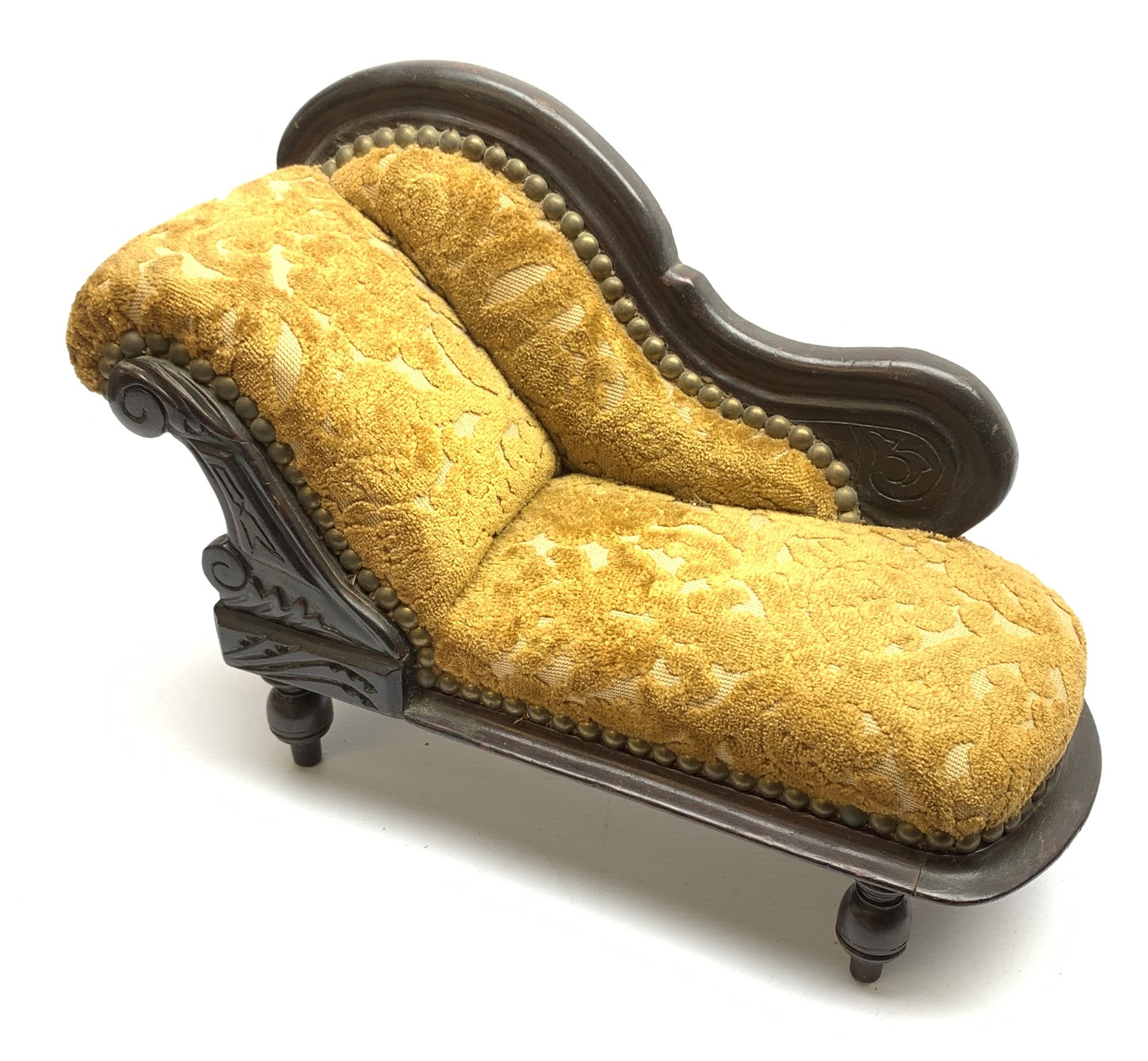 Late 19th/early 20th century doll's chaise longue with mahogany stained carved frame, scrolling back and cut dralon upholstery on four turned legs L41cm