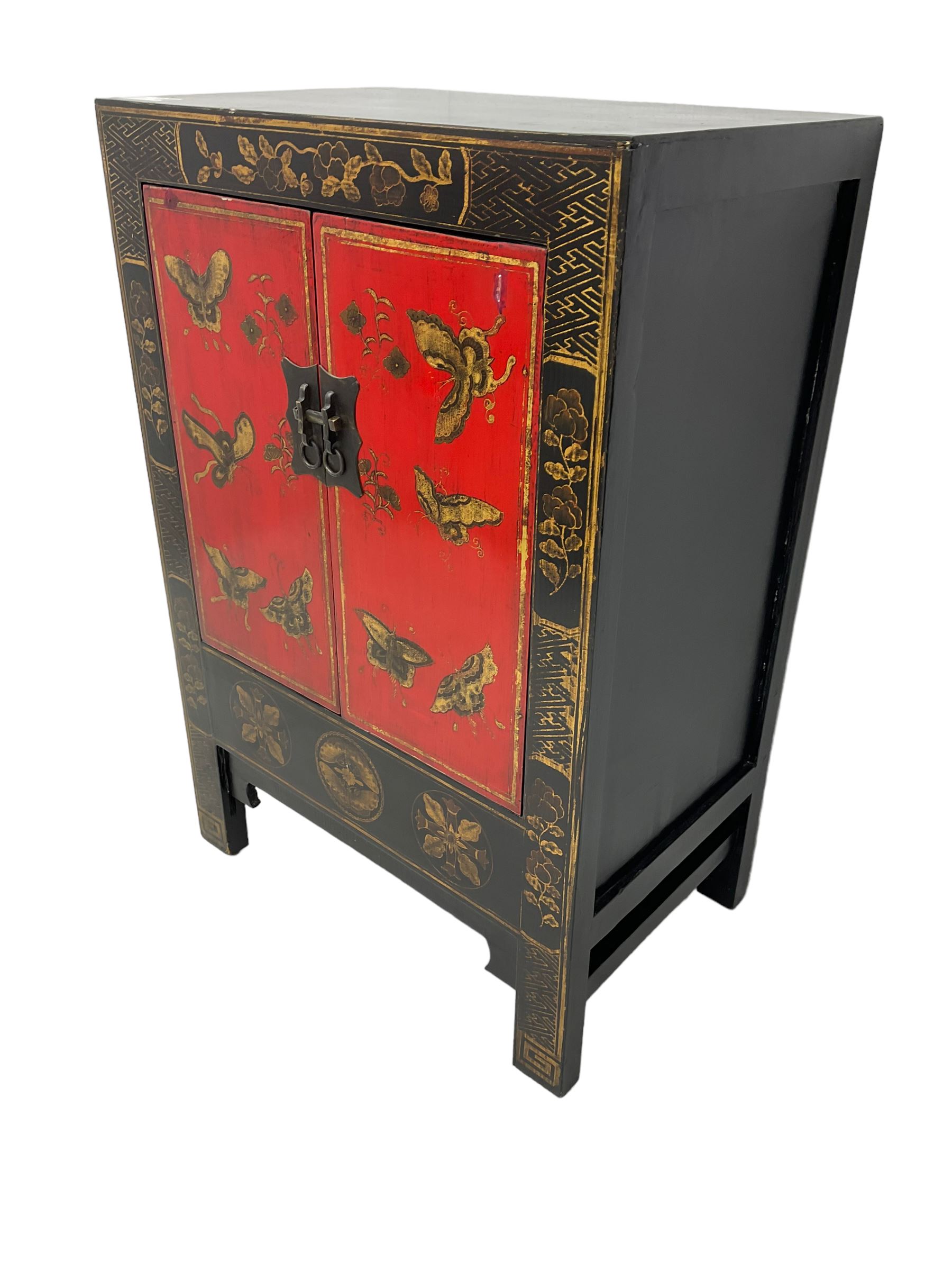 20th century Chinese black lacquered cabinet, rectangular body with two doors enclosing single shelf interior, adorned with gilt butterfly and floral motifs against a red backdrop, standing on square supports