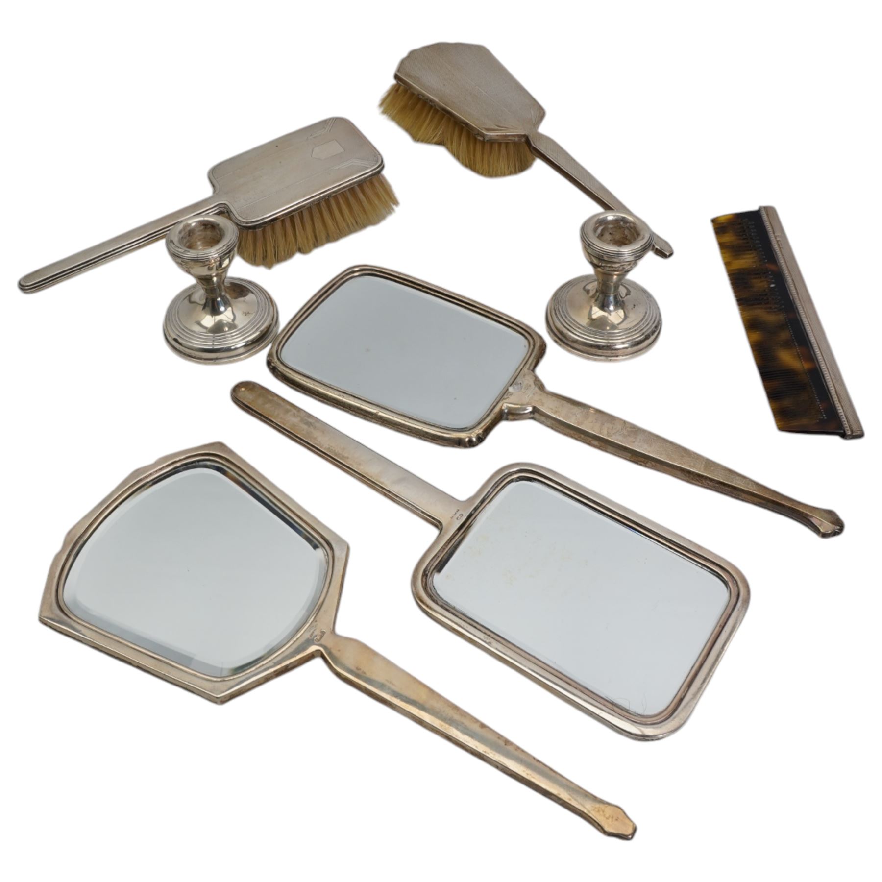 Art Deco design silver backed hand mirror and hairbrush Birmingham 1940, three others and a pair of silver dressing table candlesticks 