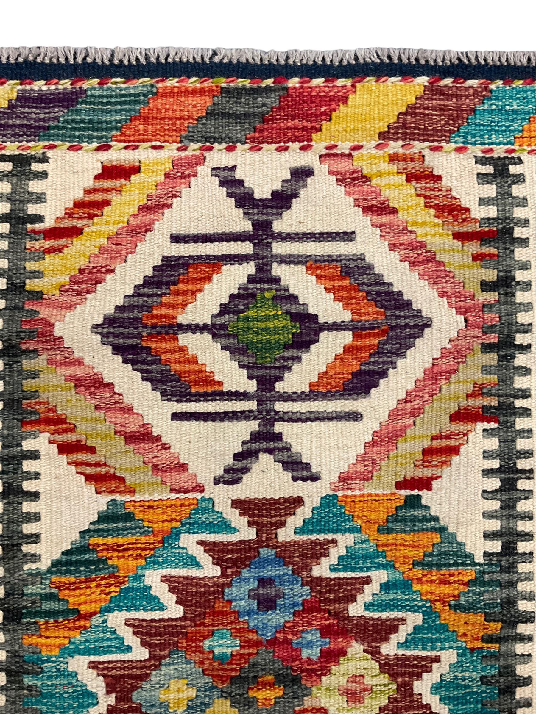 Chobi Kilim rug, pale ground and decorated with multi-coloured geometric pattern 