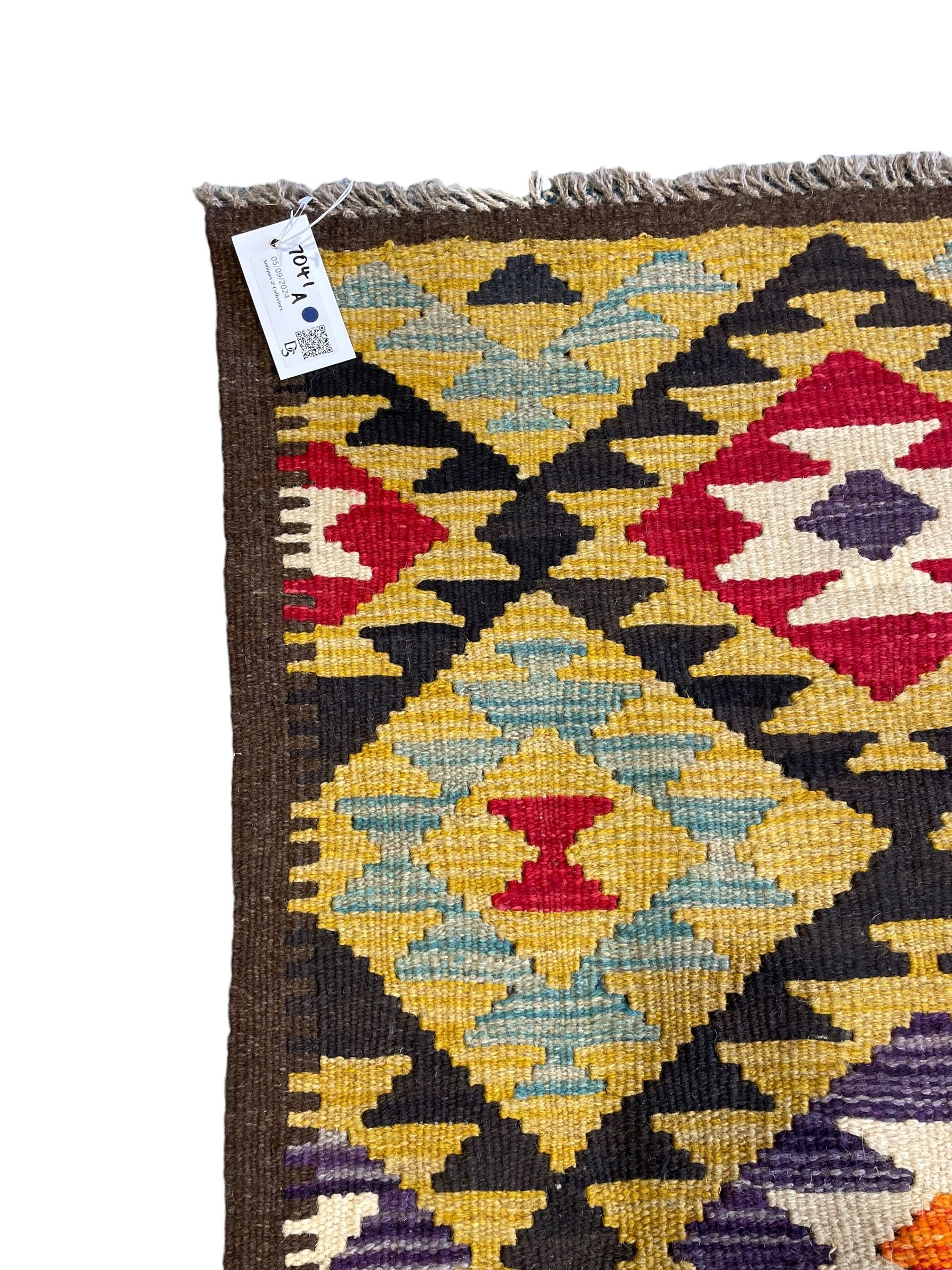 Chobi Kilim multi-colour runner rug, the field decorated with geometric lozenges in contrasting shades on brown ground