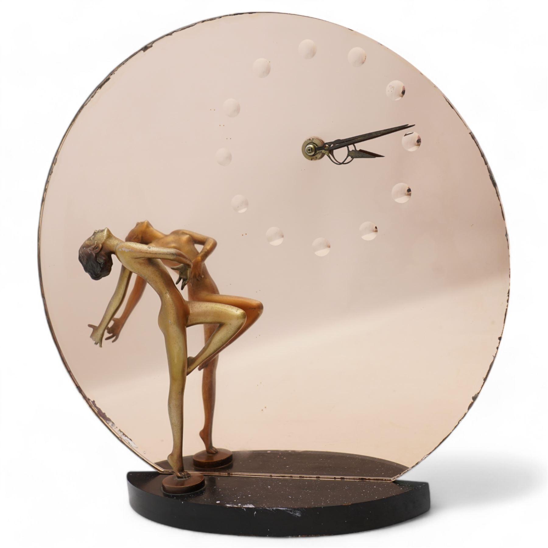 Josef Lorenzl (Austrian 1982-1950): Art Deco figural clock, circa 1930, modelled as a cold painted bronze female nude dancer before a rose-tinted mirror panel with integral clock, on ebonised plinth, the figure inscribed 'Lorenzl', with Smith's bakelite cased electric timepiece, H37.5cm x W37cm 