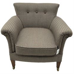 Edwardian hardwood-framed tub-shaped armchair, curved back over rolled arms, upholstered in checkered fabric with buttoned back, on square tapering supports with brass castors 