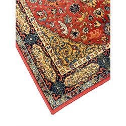 Persian design red ground rug, decorated with plant and animal motifs, the border decorated with floral design panels with guards