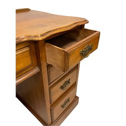 Late 19th century walnut twin pedestal desk, shaped moulded top over nine drawers, on moulded plinth base 