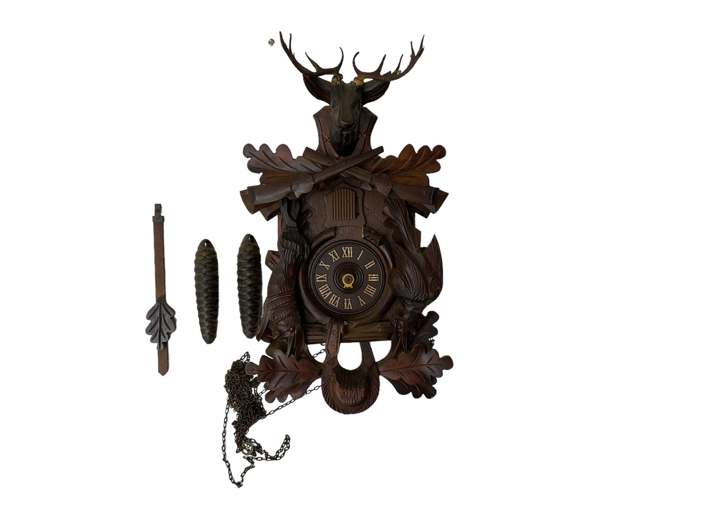 A 20th century cuckoo clock and weight driven German wall clock.