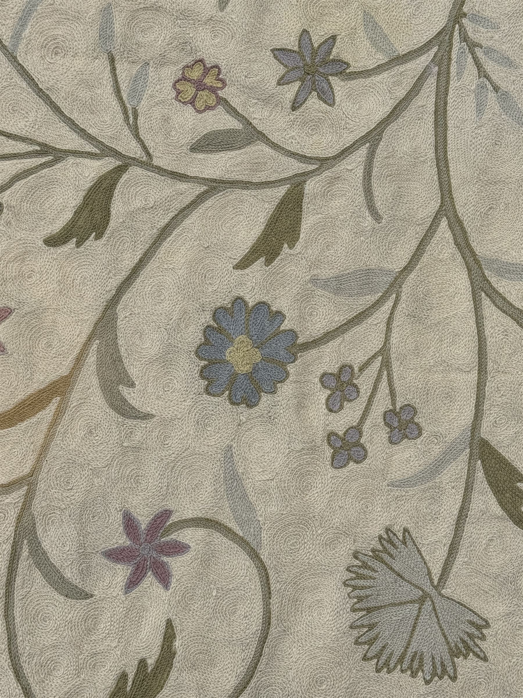 Kashmiri hand-stitched wool chain runner, featuring a cream ground decorated with meandering vines and an array of pastel flowers, enclosed by a plain light green border