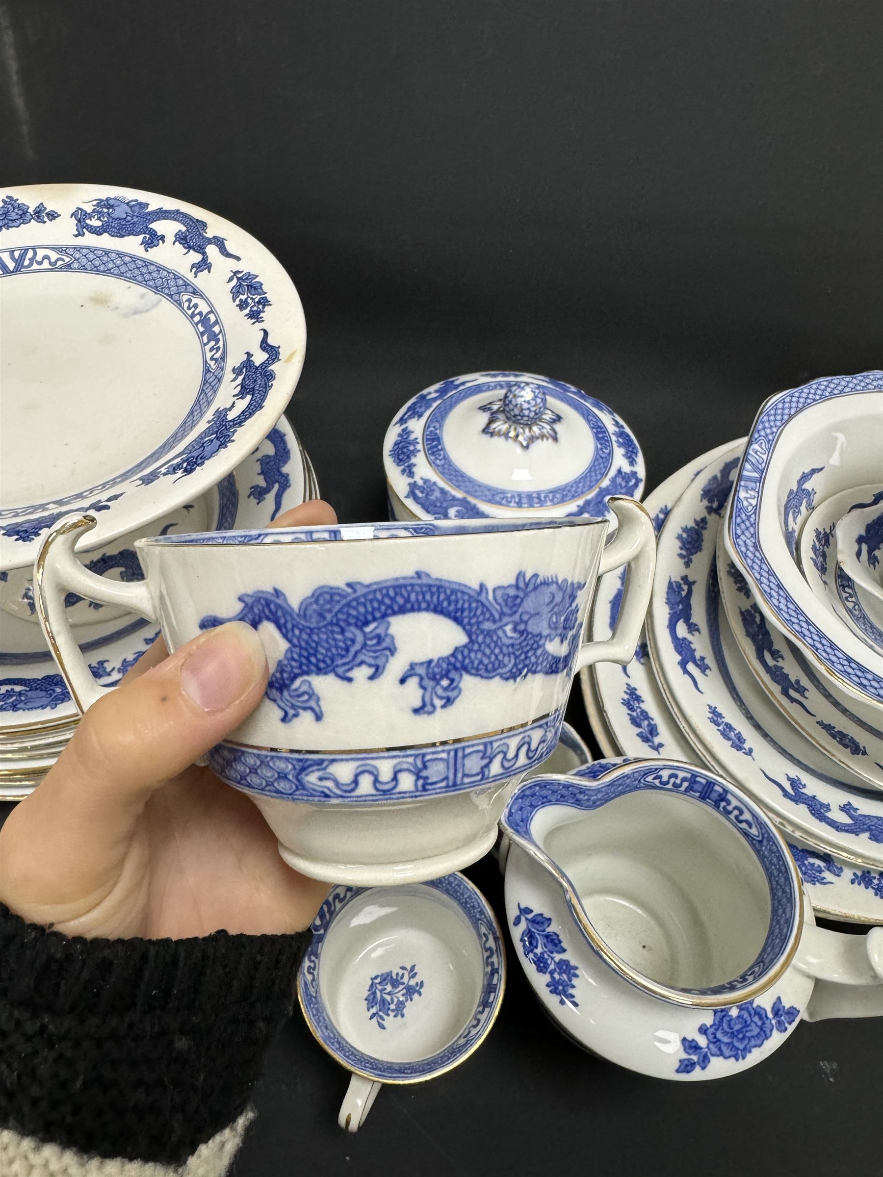 Extensive tea and dinner service of Booths and Cauldon dragon pattern, including, teapots, coffee pots, jugs, toast racks, bowls, dinner plates, platters, soup tureen etc 