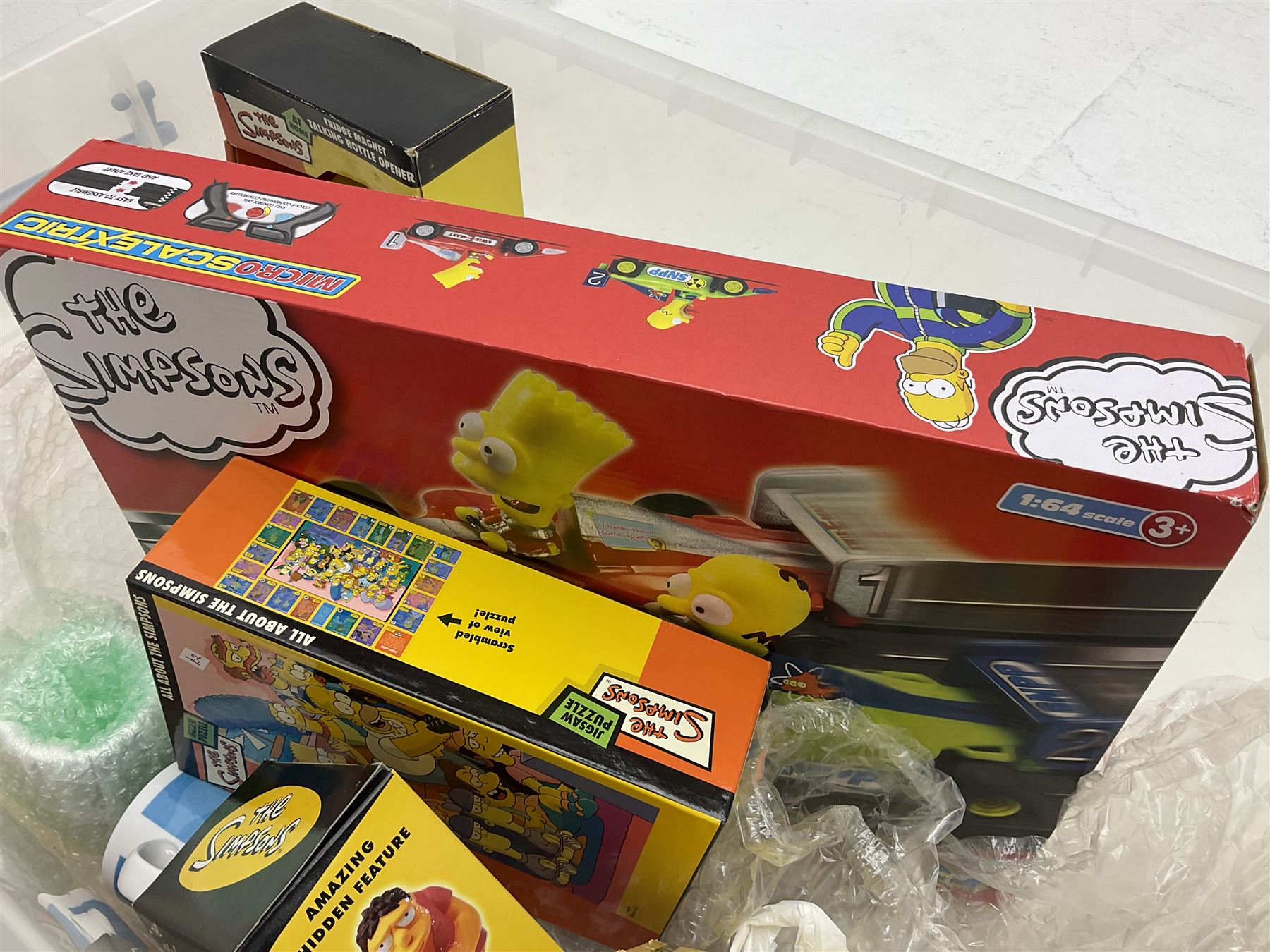 Large quantity of The Simpsons merchandise and memorabilia, to include Micro Scalextric, mugs, jigsaw, bottle openers, solar pal, glasses, etc, many boxed