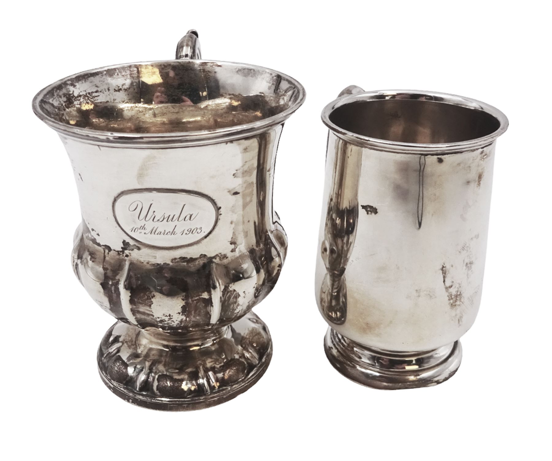 Two silver christening mugs, the first a Victorian example, of part fluted waisted form, upon circular foot with scroll handle, hallmarked Edward, John & William Barnard, London 1838, the second example of plain slightly tapering form with C handle, hallmarked S Blanckensee & Son Ltd, Chester 1929, tallest H9cm