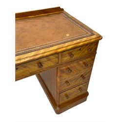 Victorian satin walnut twin pedestal desk, moulded rectangular top with rounded corners and raised back, inset leather writing surface with tooled borders, fitted with nine drawers with turned handles, on moulded plinth base 