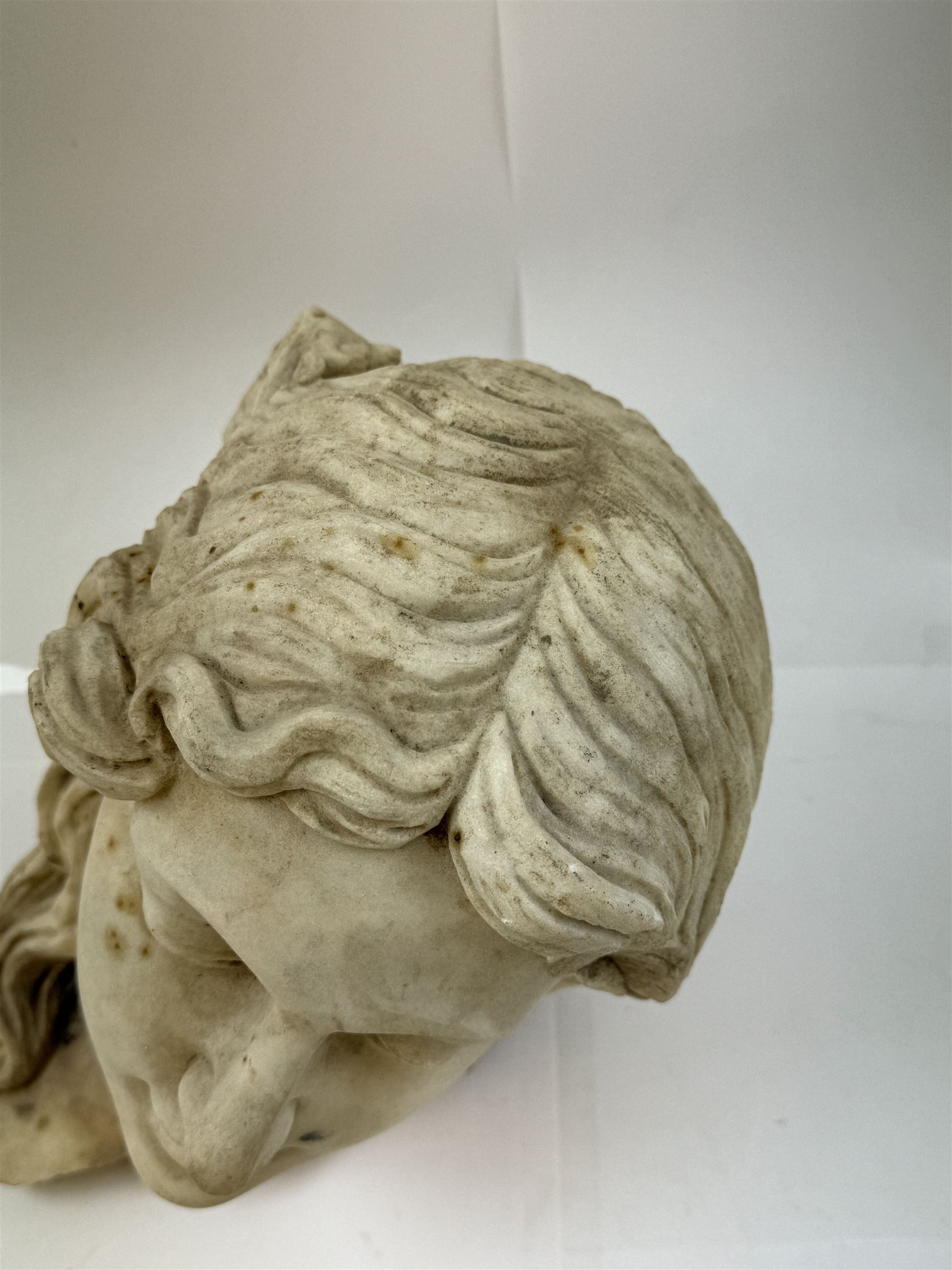 Fragmentary white marble head of a female bust, H31cm