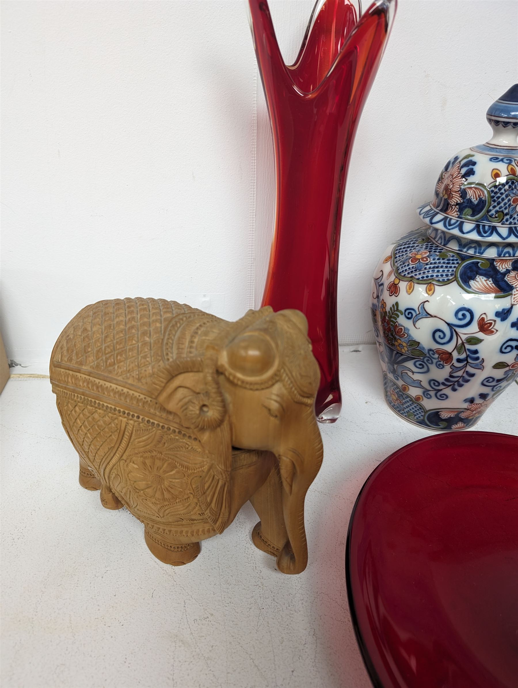 Makkum urn, collection of red art glass including large bowl and a carved wooden elephant, etc