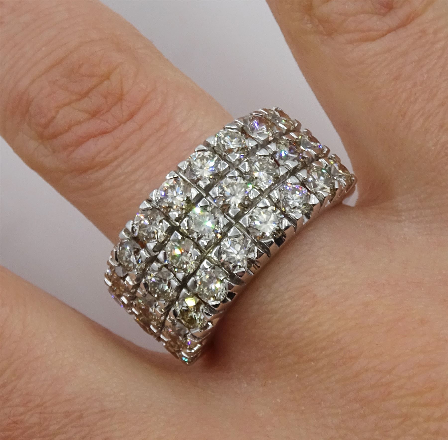 White gold three row round brilliant cut diamond half eternity ring, stamped 9K, total diamond weight 4.14 carat