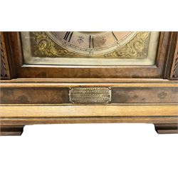 Lenzkirch - Late 19th century 8-day German mantle clock in a walnut veneered case with an architectural pediment, square brass dial, cast spandrels, matted dial centre, silvered chapter ring and fleur-di-Lis hands, with a twin train movement chiming the quarters on two coiled gongs and striking the hours on one. With Key and pendulum. Silver presentation plaque dated 1896.