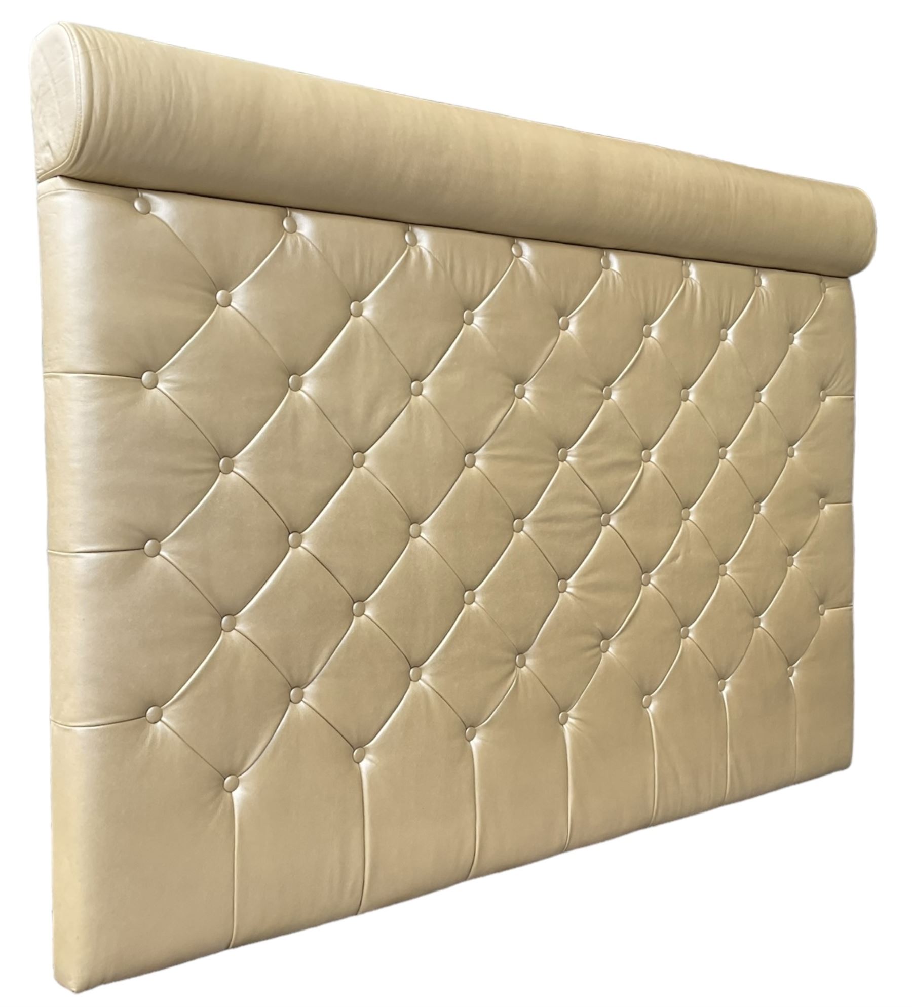 Large padded headboard, upholstered in beige buttoned faux leather