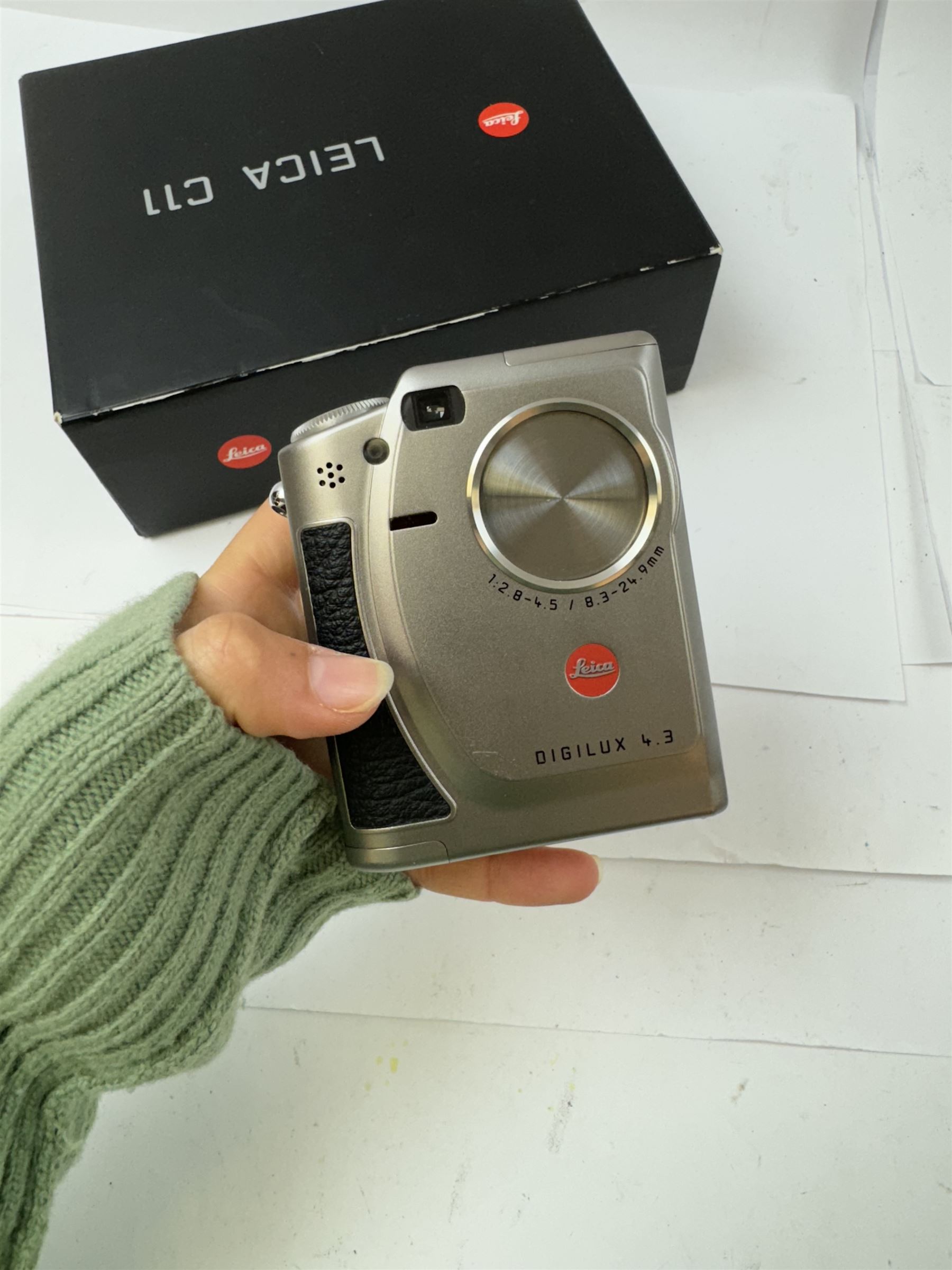 Leica C11 APS film compact camera, in silver and chrome finish, serial no. 2636834, in original clear hard case and box, with instruction booklet, together with a Leica Digilux 4.3, with 1:2.8-4.5/8.3-24.9mm lens, serial no. 2598862, with instruction booklet