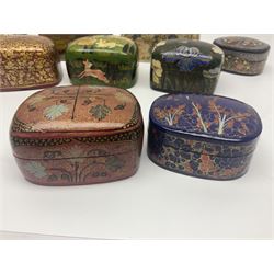 Nine lacquered boxes, all rectangular form, including russian examples decorated with animals within a stylized landscapes and example with flower decoration, largest H7cm, L11cm